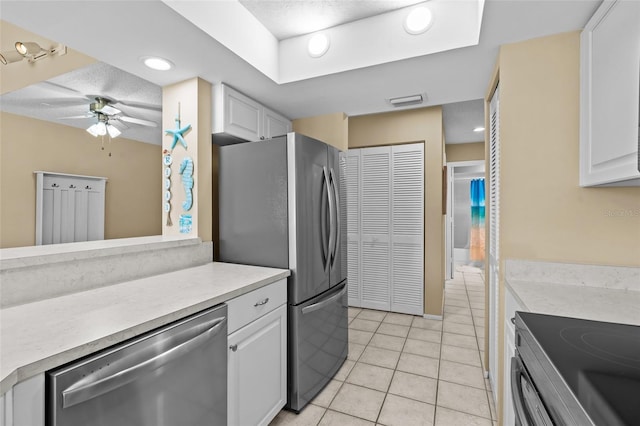 kitchen featuring white cabinets, a ceiling fan, light countertops, and appliances with stainless steel finishes