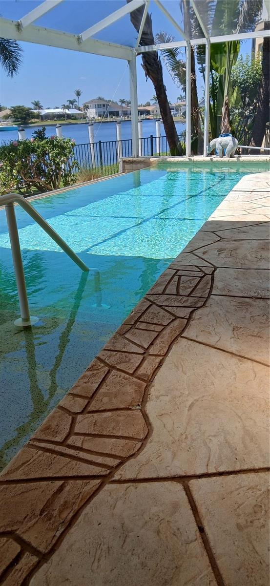 pool featuring a lanai and a water view