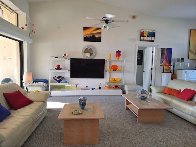 carpeted living room featuring ceiling fan and a high ceiling