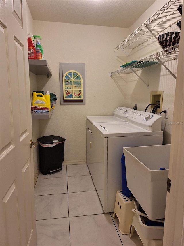 clothes washing area with laundry area, a sink, and washer and clothes dryer