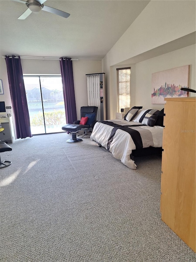 bedroom featuring carpet floors, a ceiling fan, vaulted ceiling, and access to exterior