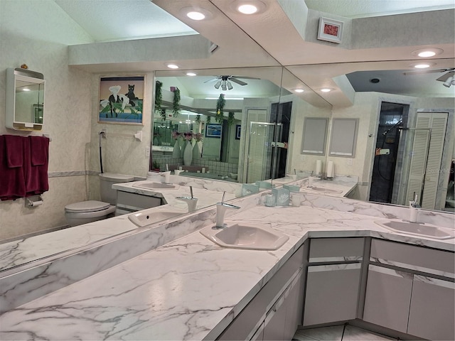 full bath featuring a sink, a ceiling fan, and toilet