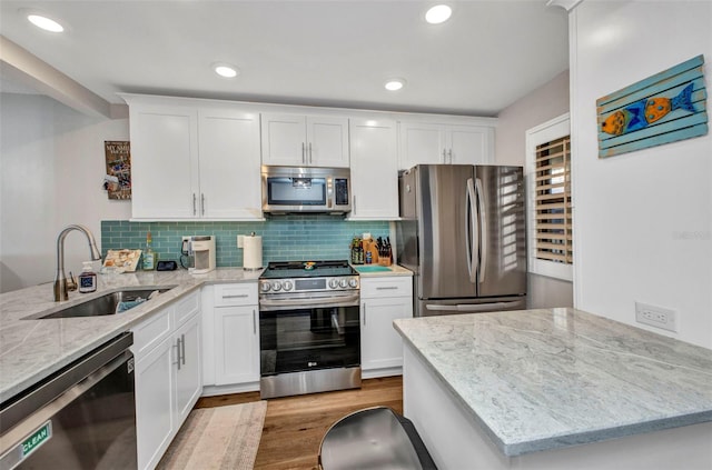 1701 Beach Rd Unit 305, Englewood, FL 34223 - kitchen with a sink, light wood-type flooring, a peninsula, and stainless steel appliances