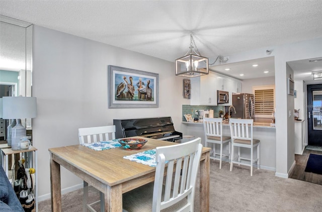 1701 Beach Rd Unit 305, Englewood, FL 34223 - dining space with a chandelier, light colored carpet, and baseboards