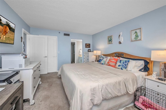 1701 Beach Rd Unit 305, Englewood, FL 34223 - bedroom featuring visible vents, connected bathroom, light colored carpet, and a textured ceiling