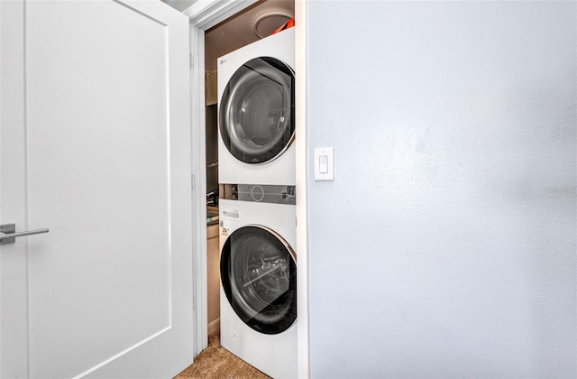 1701 Beach Rd Unit 305, Englewood, FL 34223 - clothes washing area featuring stacked washer / dryer, laundry area, and carpet floors