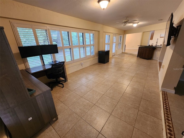 243 Harbor Blvd, Port Charlotte, FL 33954 - office area featuring light tile patterned floors, a ceiling fan, and baseboards