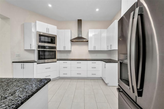4213 Gardner Dr, Port Charlotte, FL 33952 - kitchen with appliances with stainless steel finishes, wall chimney exhaust hood, white cabinets, dark stone counters, and recessed lighting