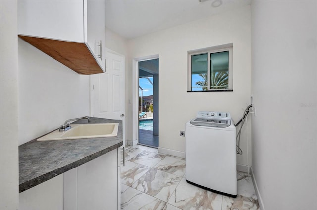 4213 Gardner Dr, Port Charlotte, FL 33952 - laundry room with washer / dryer, cabinet space, light marble finish floors, and baseboards