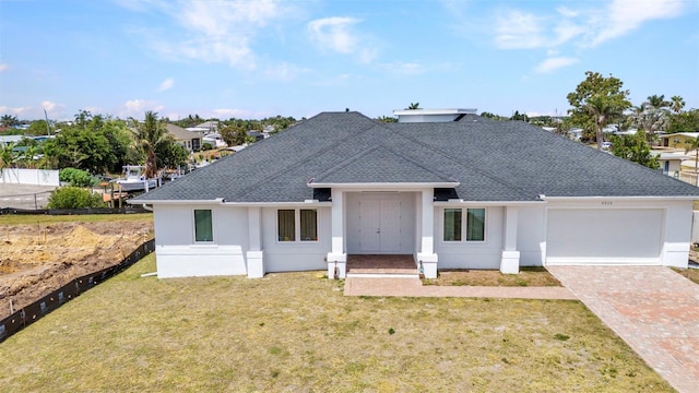 4213 Gardner Dr, Port Charlotte, FL 33952 - view of front of property with a shingled roof, an attached garage, a front lawn, decorative driveway, and stucco siding