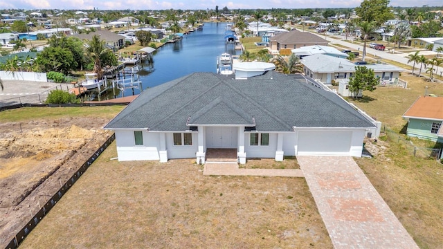 4213 Gardner Dr, Port Charlotte, FL 33952 - view of front of home featuring roof with shingles, an attached garage, a water view, decorative driveway, and a residential view