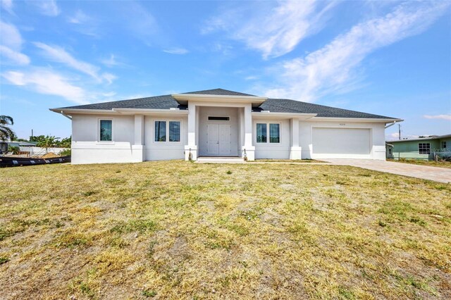4213 Gardner Dr, Port Charlotte, FL 33952 - prairie-style house with stucco siding, driveway, an attached garage, and a front lawn