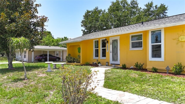 582 Ridgewood St NW, Port Charlotte, FL 33952 - ranch-style house with a front lawn and a shingled roof