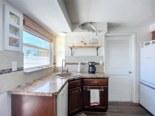 582 Ridgewood St NW, Port Charlotte, FL 33952 - kitchen featuring a sink, freestanding refrigerator, a textured ceiling, dishwasher, and decorative backsplash