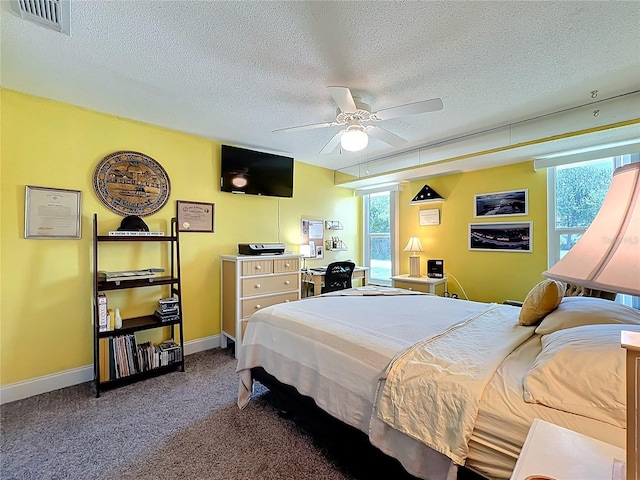 582 Ridgewood St NW, Port Charlotte, FL 33952 - bedroom with a textured ceiling, multiple windows, carpet floors, baseboards, and ceiling fan