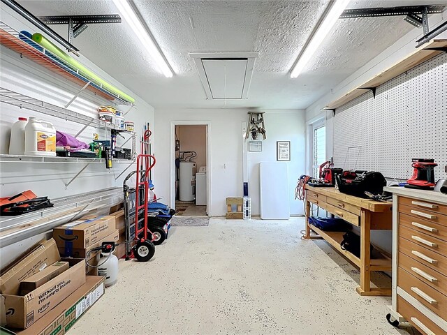 582 Ridgewood St NW, Port Charlotte, FL 33952 - garage with electric water heater, a workshop area, and washer / clothes dryer