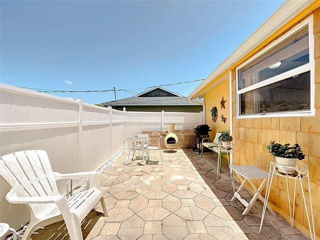 582 Ridgewood St NW, Port Charlotte, FL 33952 - fenced backyard featuring a patio and outdoor dining space