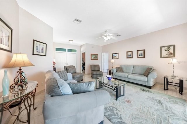 living area with tile patterned floors and a ceiling fan