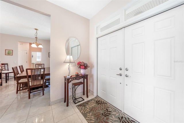 entryway with light tile patterned floors and baseboards