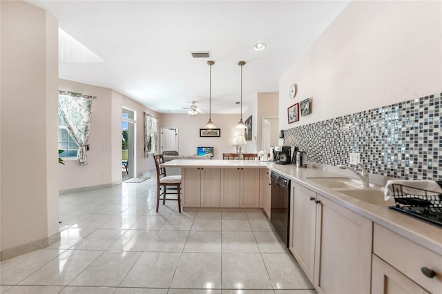 kitchen with open floor plan, a peninsula, dishwasher, light countertops, and light tile patterned flooring
