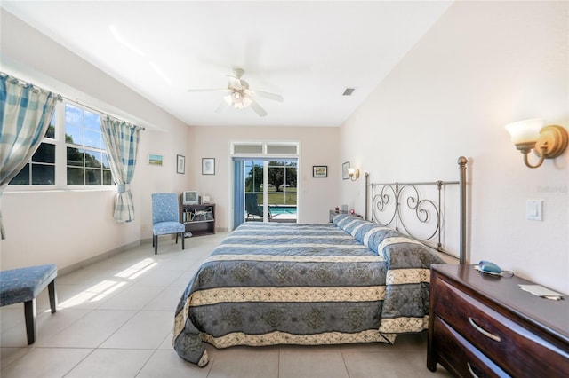 bedroom with multiple windows, tile patterned flooring, and access to outside
