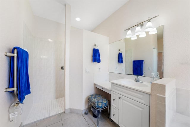 full bathroom featuring tile patterned floors, vanity, and a walk in shower