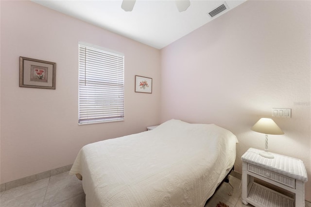 tiled bedroom with baseboards and ceiling fan
