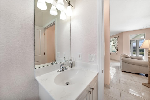 bathroom featuring a textured wall, tile patterned flooring, and vanity