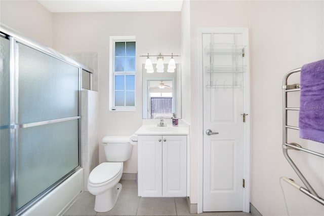 bathroom with tile patterned floors, toilet, vanity, and shower / bath combination with glass door