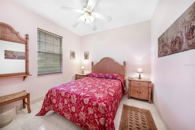bedroom with light tile patterned floors, a ceiling fan, and baseboards
