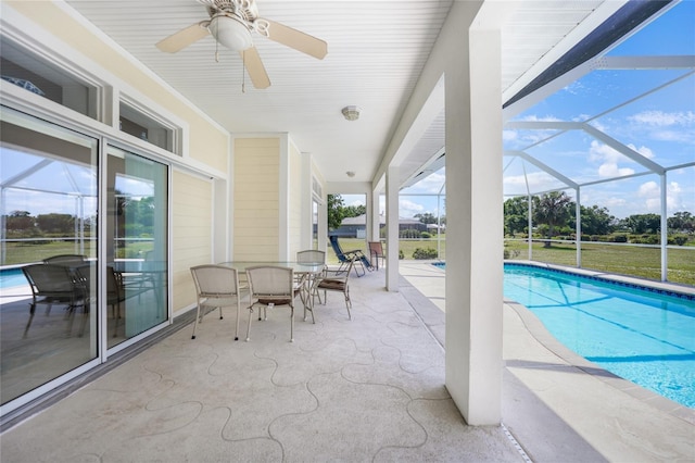 outdoor pool featuring a patio, a ceiling fan, a lanai, and outdoor dining space