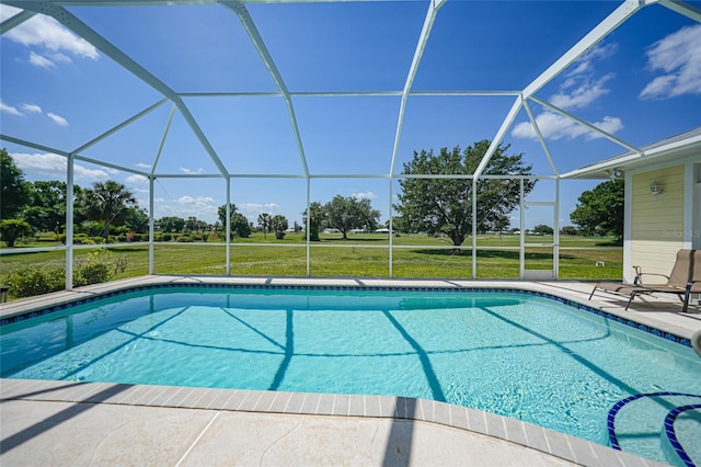 swimming pool featuring a yard, a lanai, and a patio