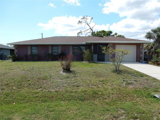 582 Reading St NW, Port Charlotte, FL 33952 - ranch-style home with concrete driveway, central air condition unit, stucco siding, an attached garage, and a front yard
