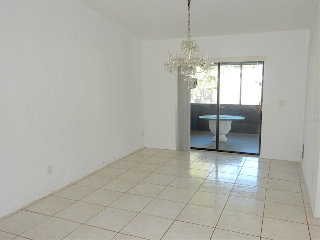582 Reading St NW, Port Charlotte, FL 33952 - empty room featuring a chandelier and light tile patterned floors