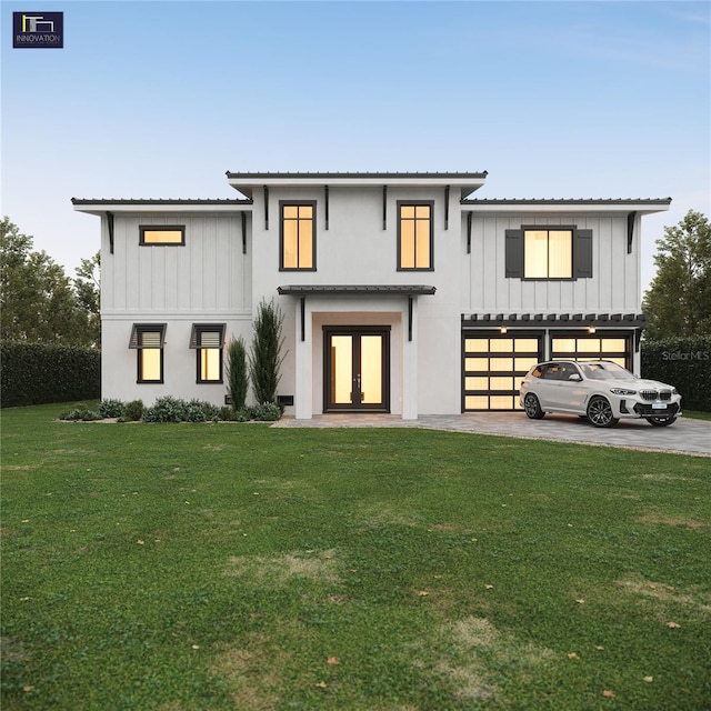 2560 Baybreeze St, Saint James City, FL 33956 - modern farmhouse style home with an attached garage, a front yard, board and batten siding, and french doors