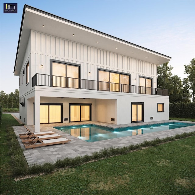 2560 Baybreeze St, Saint James City, FL 33956 - back of house featuring an outdoor pool, a patio, and a balcony
