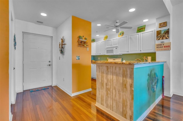 reception area with ceiling fan and visible vents