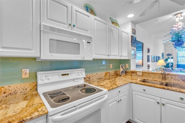 kitchen featuring a sink, decorative backsplash, white cabinets, and white appliances