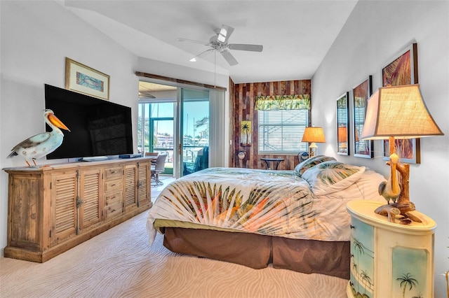 bedroom featuring access to outside, a ceiling fan, and multiple windows