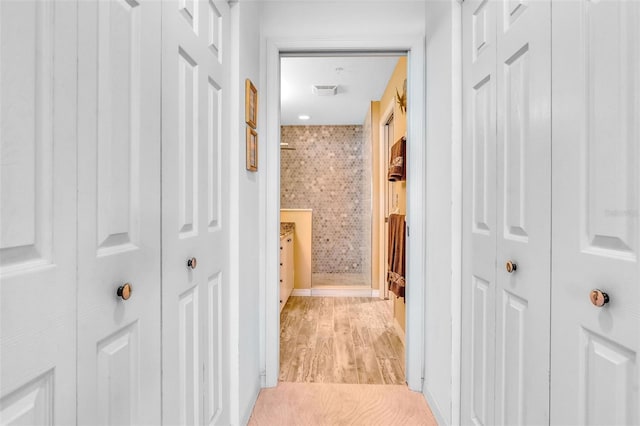 hall with visible vents and light wood-style flooring