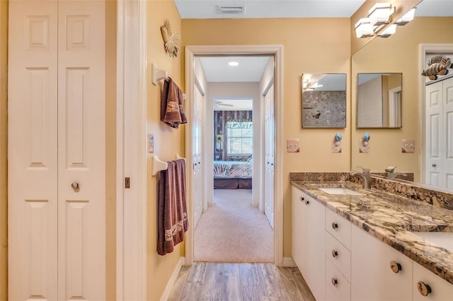 full bath featuring a sink, a closet, double vanity, and visible vents