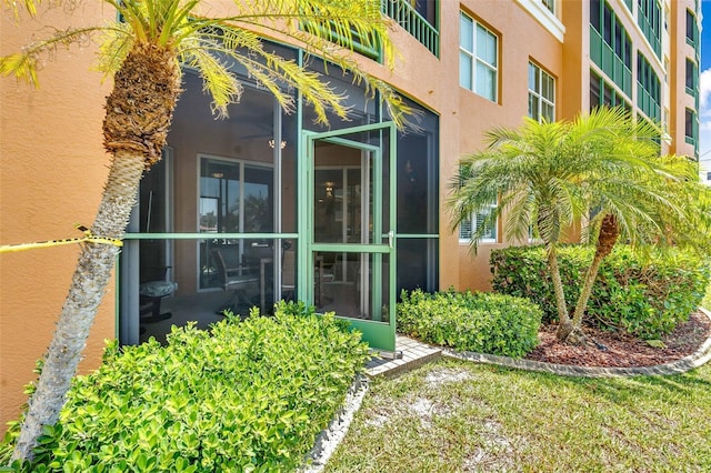 view of exterior entry with stucco siding