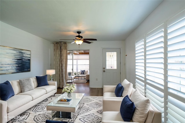 living area with ceiling fan and wood finished floors