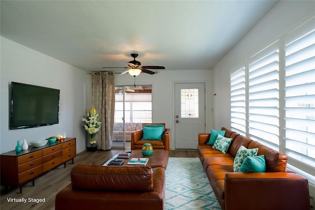 living room featuring wood finished floors and ceiling fan