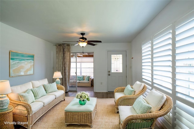 living room with a ceiling fan and wood finished floors