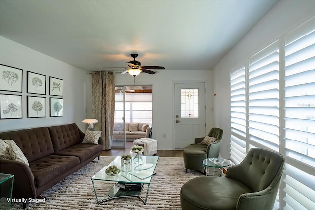 living area featuring wood finished floors and ceiling fan