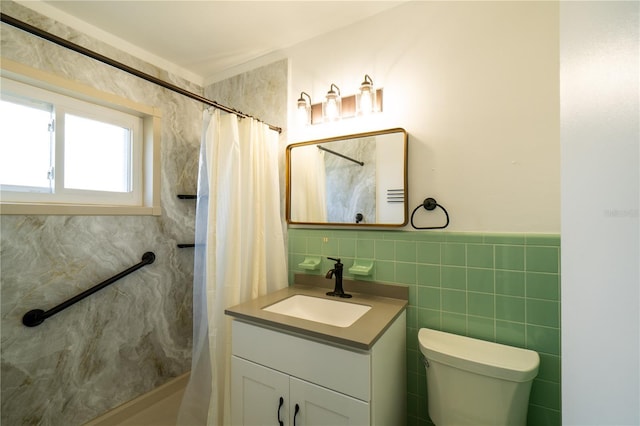 full bathroom with tile walls, toilet, and vanity