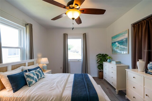 bedroom featuring wood finished floors, ceiling fan, and baseboards