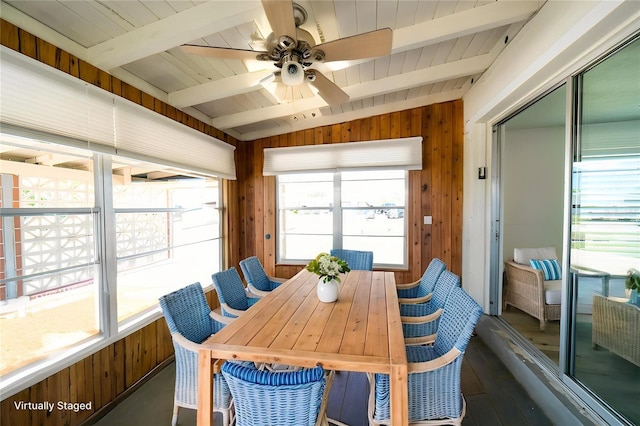 sunroom with beamed ceiling and a ceiling fan