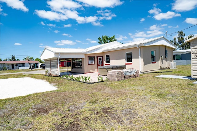 back of house with a carport, cooling unit, a yard, an outdoor hangout area, and a patio